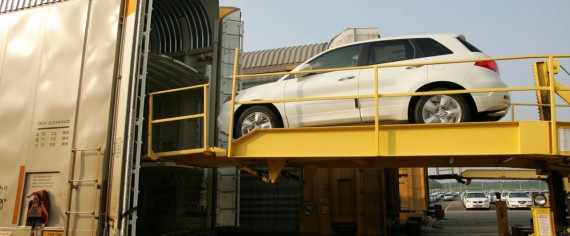 A Honda SUV being loaded into a semi