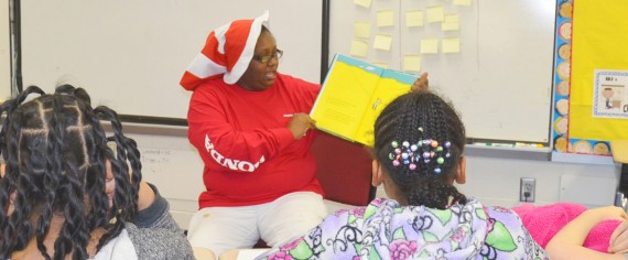 : A Honda associate reads to a class of elementary school students.