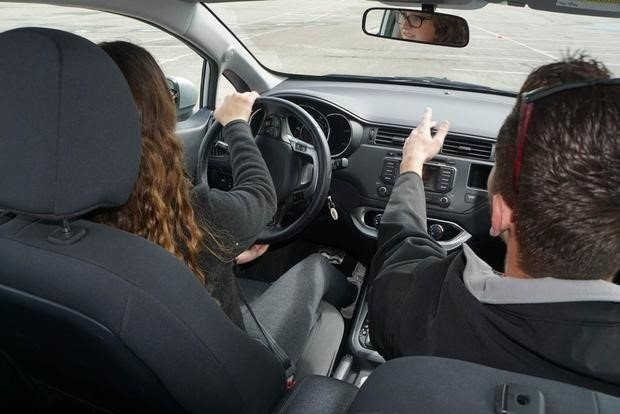 Student driver and teacher in a car.